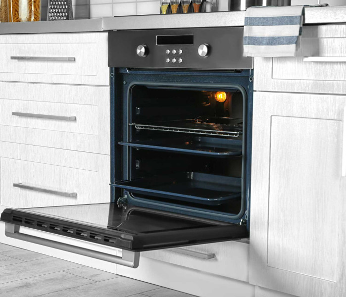 Perfectly cleaned, open oven in a bright kitchen